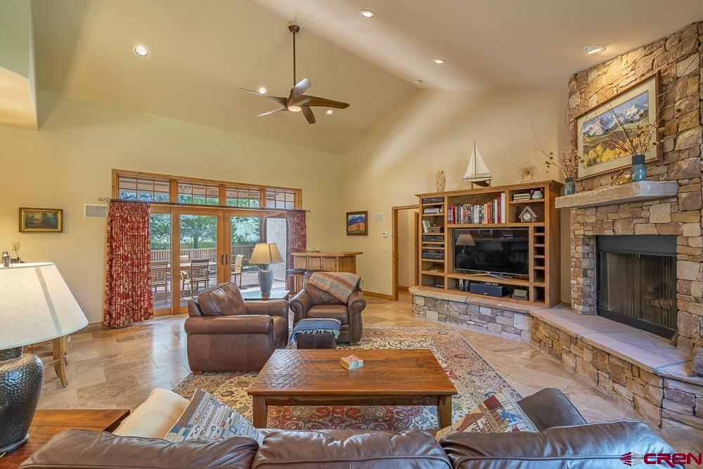 970 Red Rock Road Durango, CO 81301 - Photo 4 of 35 a living room with furniture a flat screen tv and a fireplace