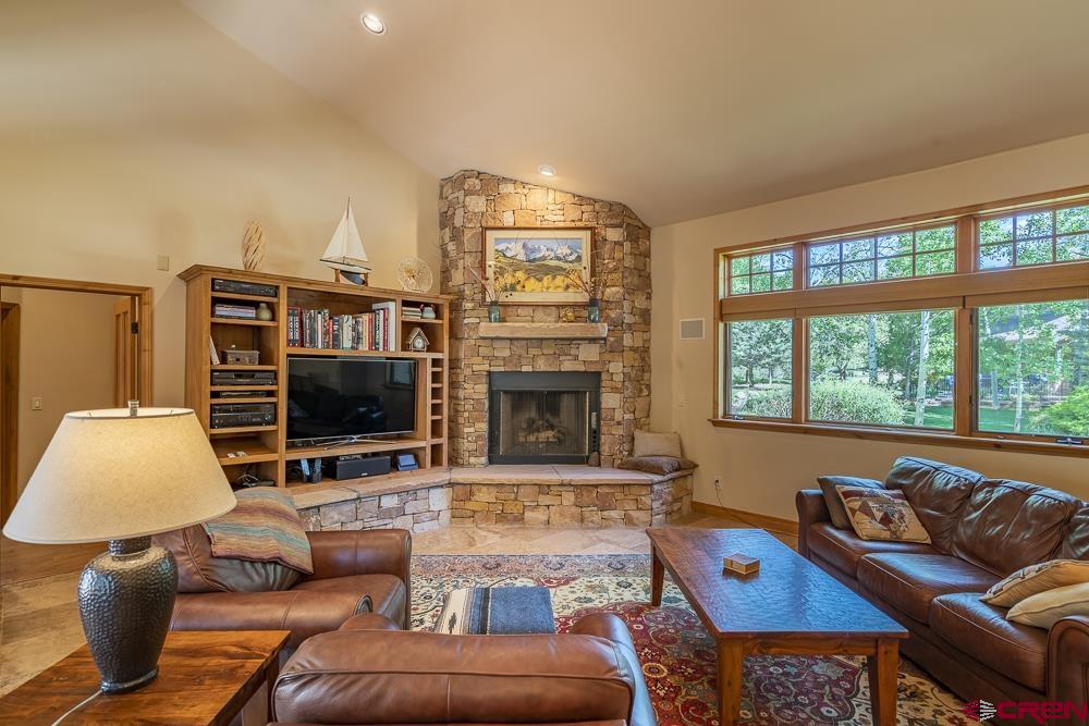 970 Red Rock Road Durango, CO 81301 - Photo 9 of 35 a living room with furniture a flat screen tv and a fireplace