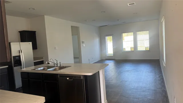 a view wooden floor and bathroom with a sink