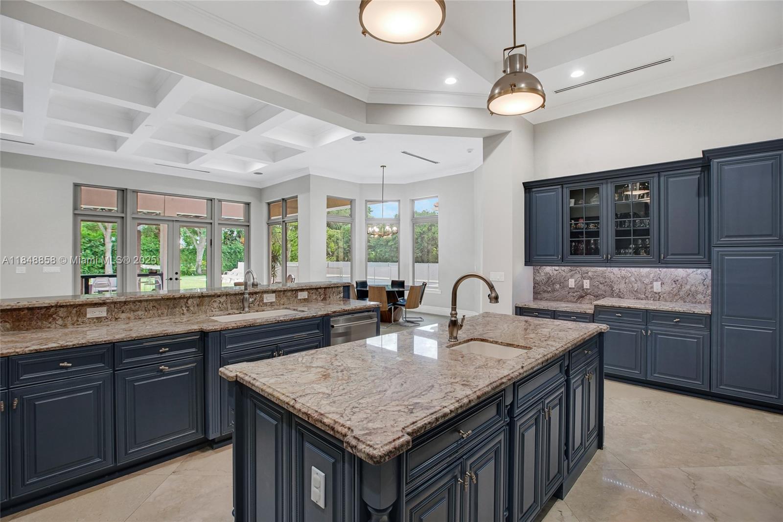 741 Ranch Road Weston, FL 33326 - Photo 14 of 35 a kitchen with center island a sink stainless steel appliances and window