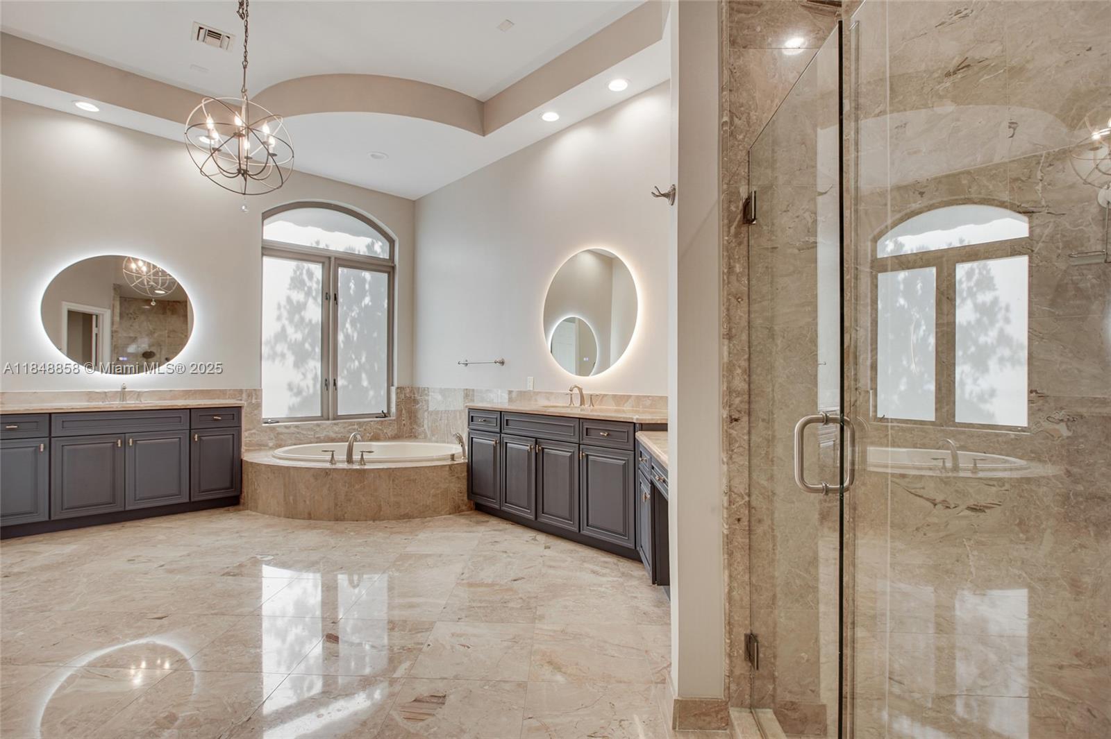 741 Ranch Road Weston, FL 33326 - Photo 18 of 35 a bathroom with a double vanity sink a mirror and a bathtub