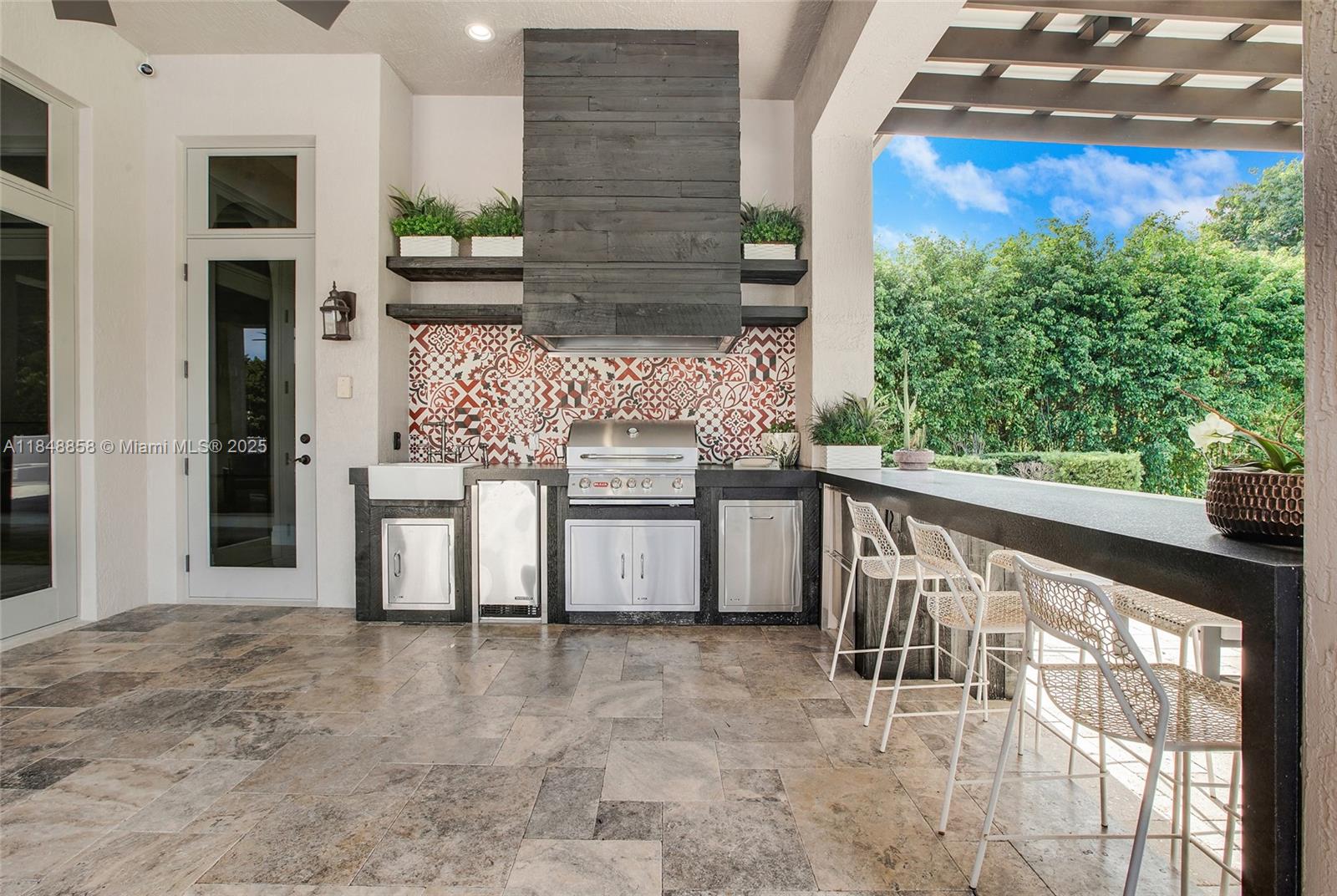 741 Ranch Road Weston, FL 33326 - Photo 28 of 35 a view of a balcony with chairs and a stove