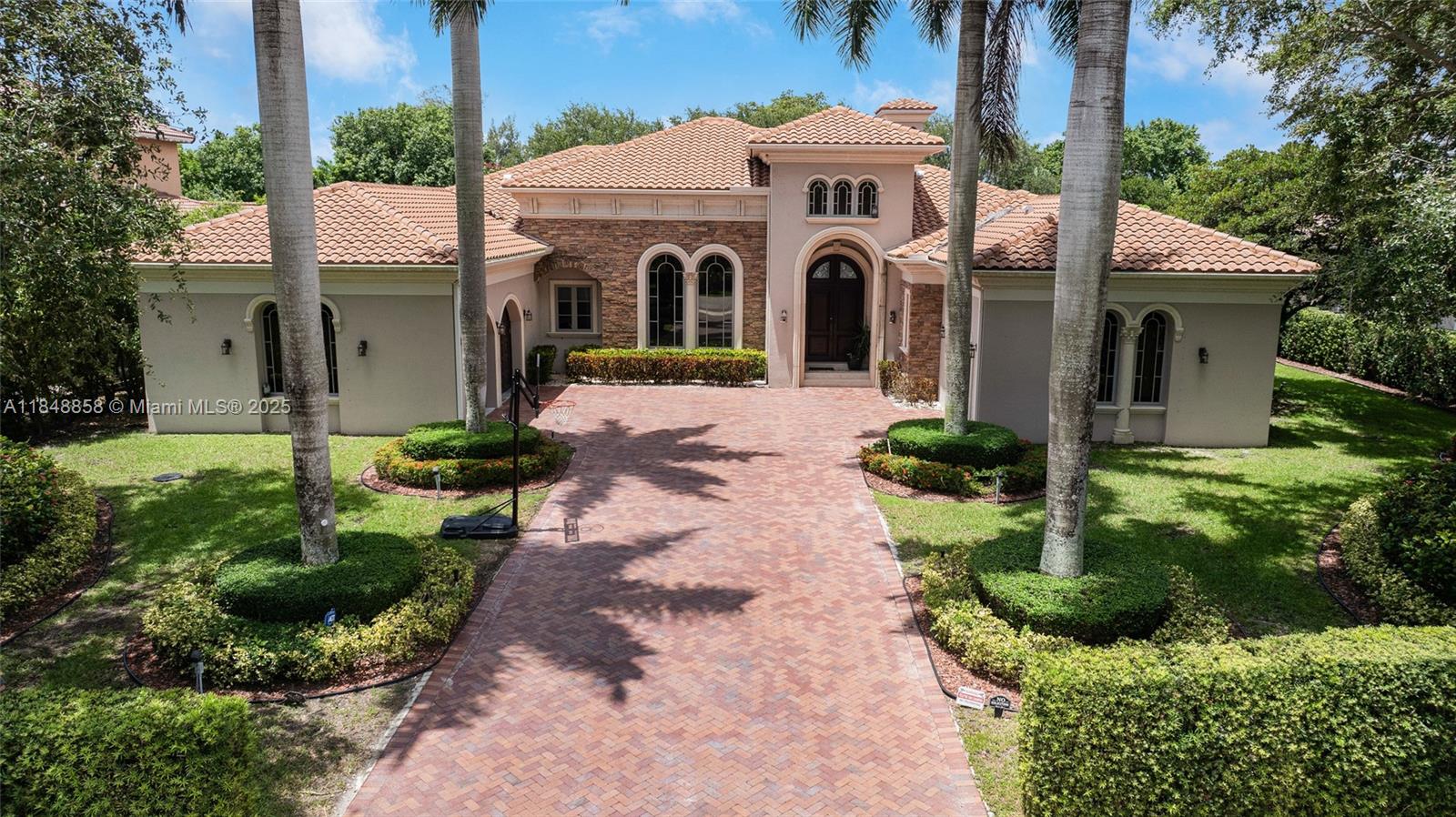 741 Ranch Road Weston, FL 33326 - Photo 30 of 35 a view of a white house with a yard and plants