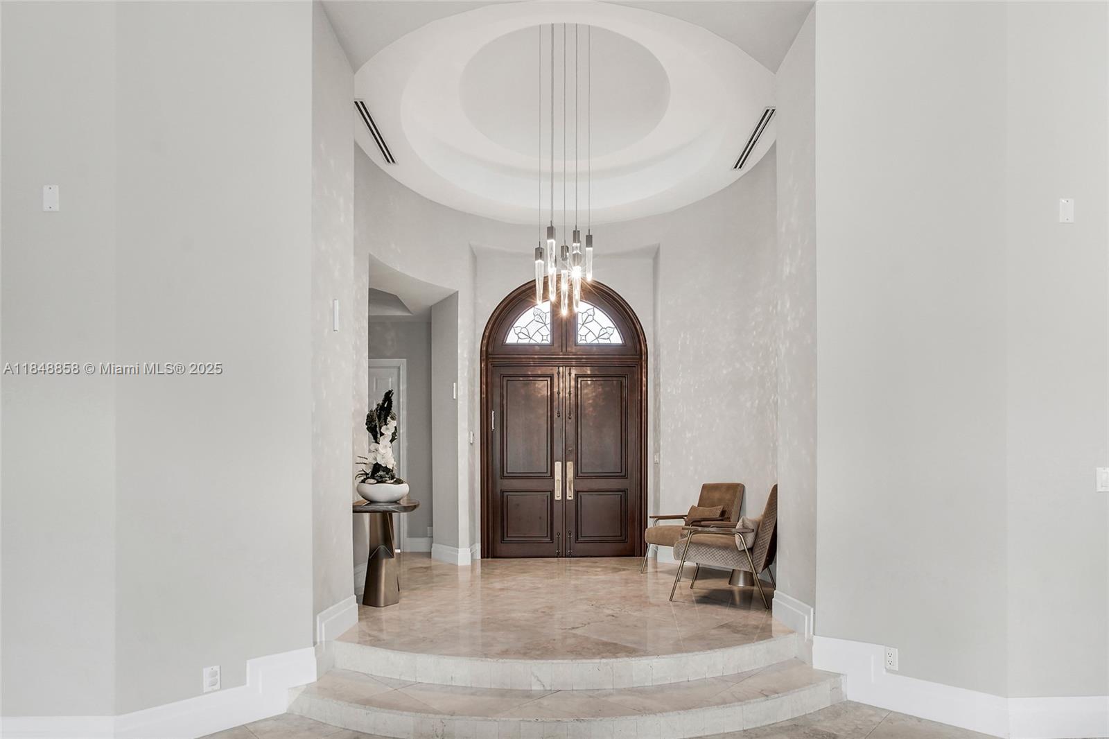 741 Ranch Road Weston, FL 33326 - Photo 3 of 35 a living room with furniture and a chandelier