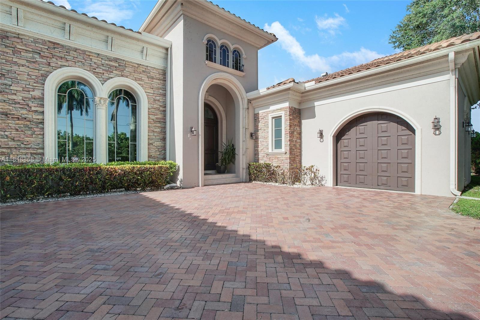 741 Ranch Road Weston, FL 33326 - Photo 10 of 35 a view of a grey house with entryway