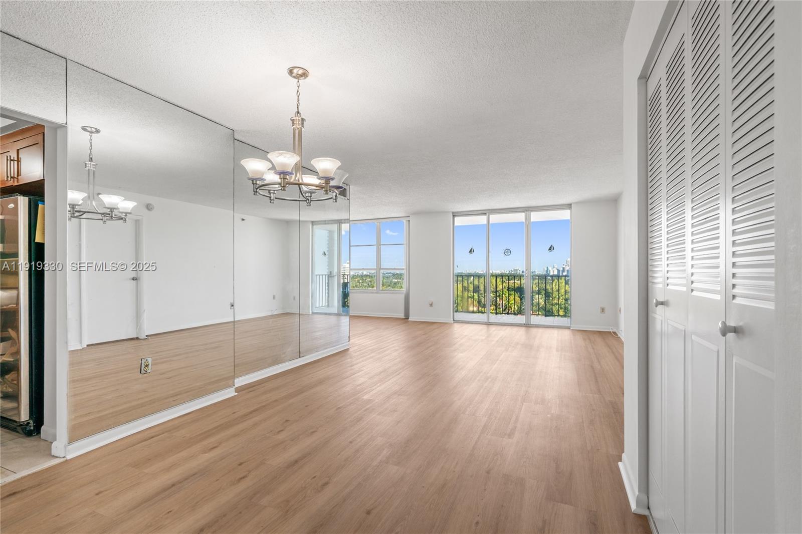 4101 Pine Tree Drive, Unit 1112 Miami Beach, FL 33140 - Photo 11 of 62 a view of a room with wooden floor and windows