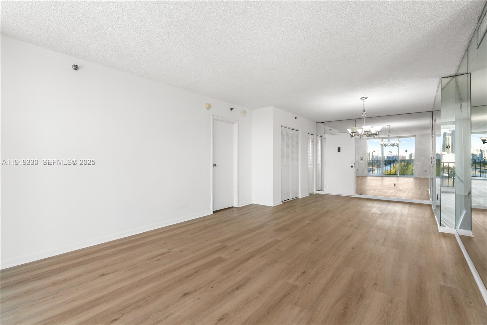 4101 Pine Tree Drive, Unit 1112 Miami Beach, FL 33140 - Photo 14 of 62 a view of empty room with wooden floor