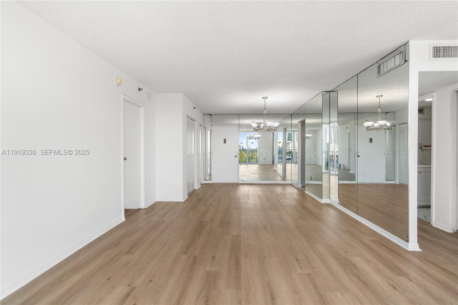 4101 Pine Tree Drive, Unit 1112 Miami Beach, FL 33140 - Photo 15 of 62 a view of empty room with wooden floor