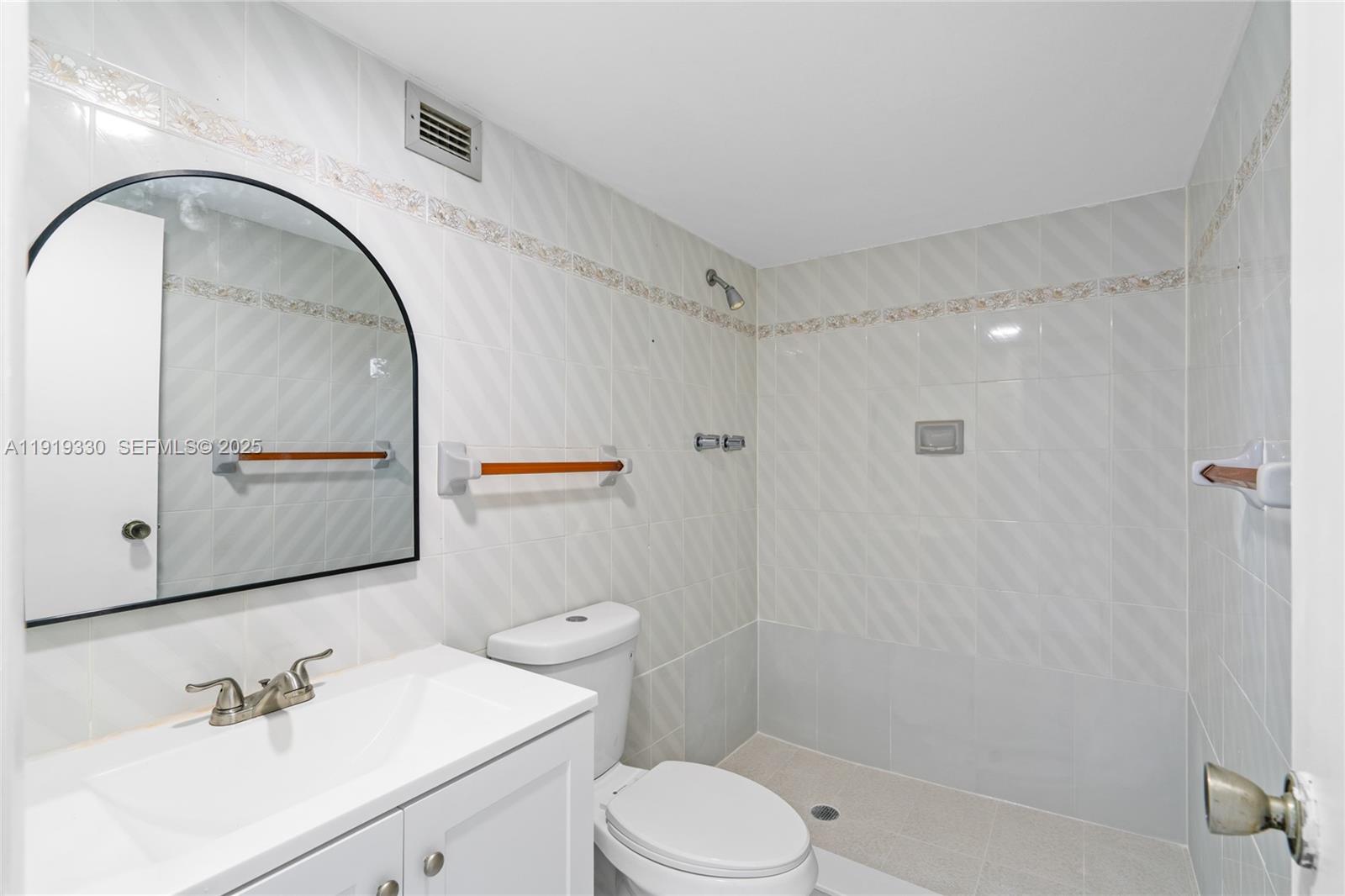 4101 Pine Tree Drive, Unit 1112 Miami Beach, FL 33140 - Photo 23 of 62 a bathroom with a sink a toilet and shower