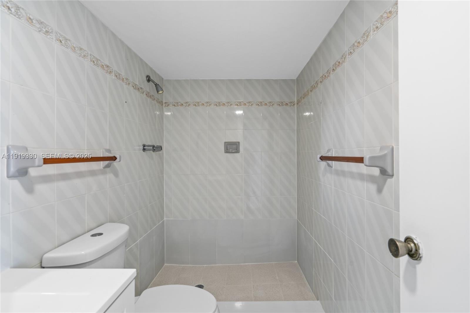 4101 Pine Tree Drive, Unit 1112 Miami Beach, FL 33140 - Photo 24 of 62 a bathroom with a shower a toilet and a sink