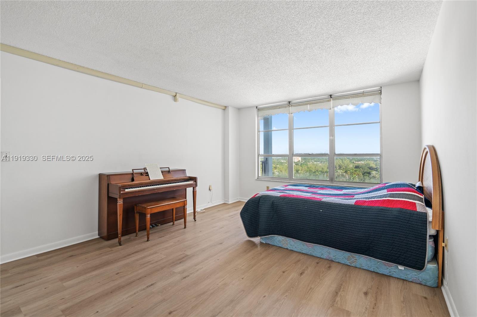 4101 Pine Tree Drive, Unit 1112 Miami Beach, FL 33140 - Photo 28 of 62 a bedroom with a bed and a window