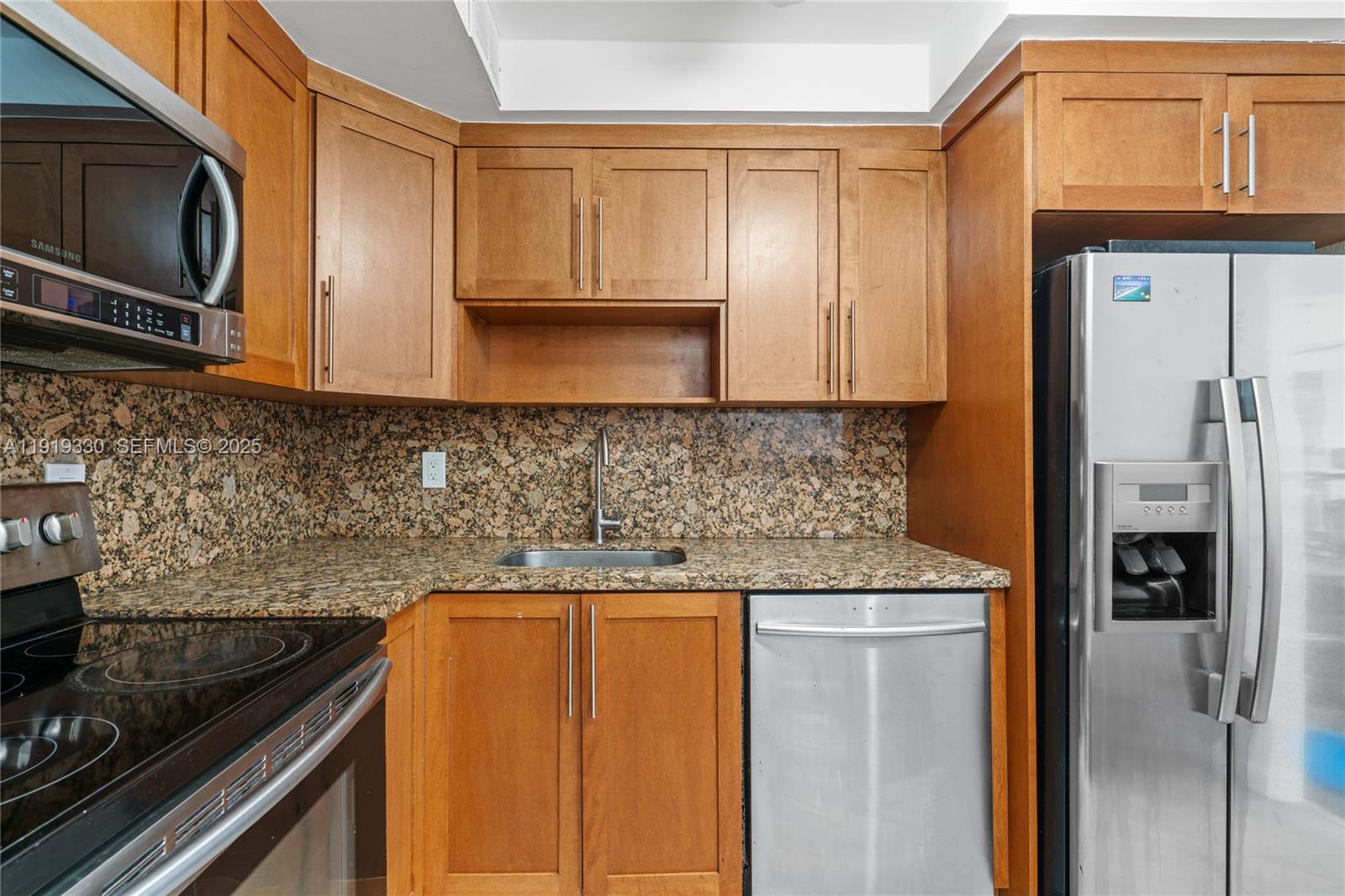 4101 Pine Tree Drive, Unit 1112 Miami Beach, FL 33140 - Photo 10 of 62 a kitchen with granite countertop stainless steel appliances and cabinets