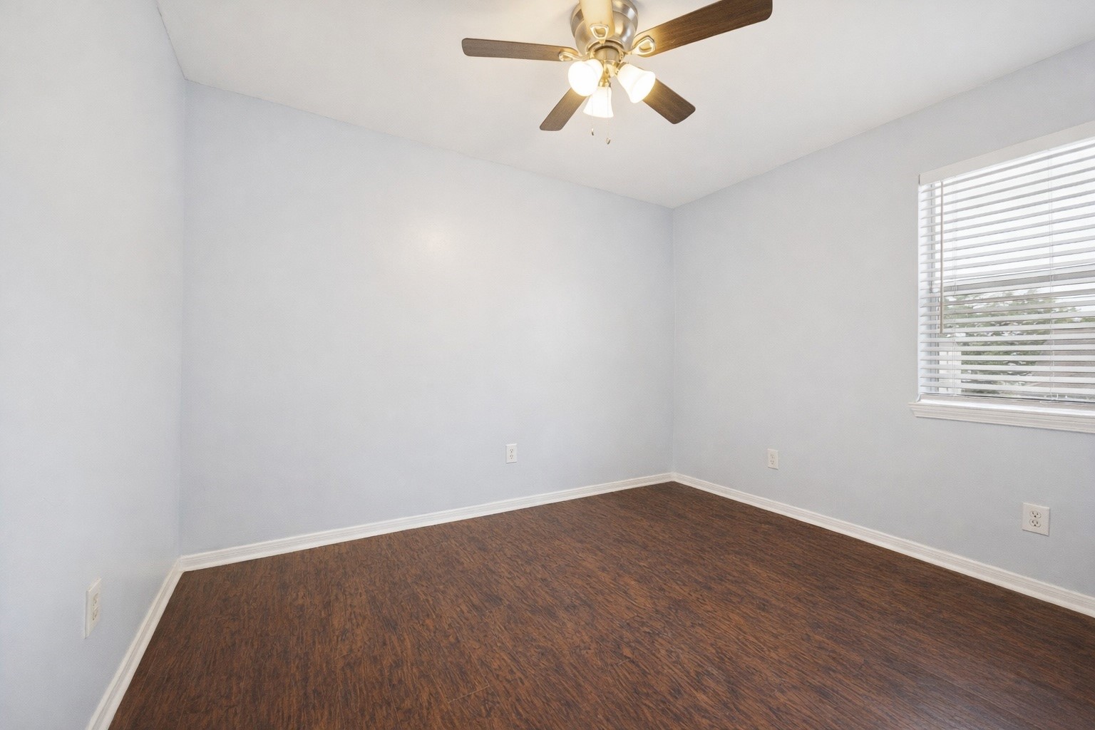 2614 Cleburne Street Houston, TX 77004 - Photo 11 of 17 an empty room with wooden floor fan and windows