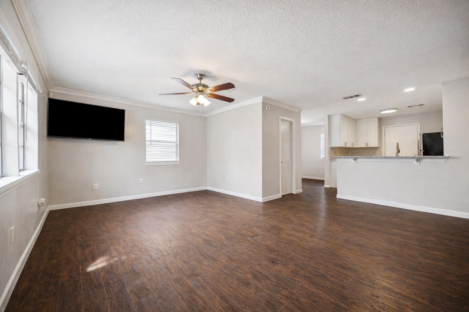 2614 Cleburne Street Houston, TX 77004 - Photo 3 of 17 a view of a kitchen with a dishwasher a kitchen island hardwood floor and a window