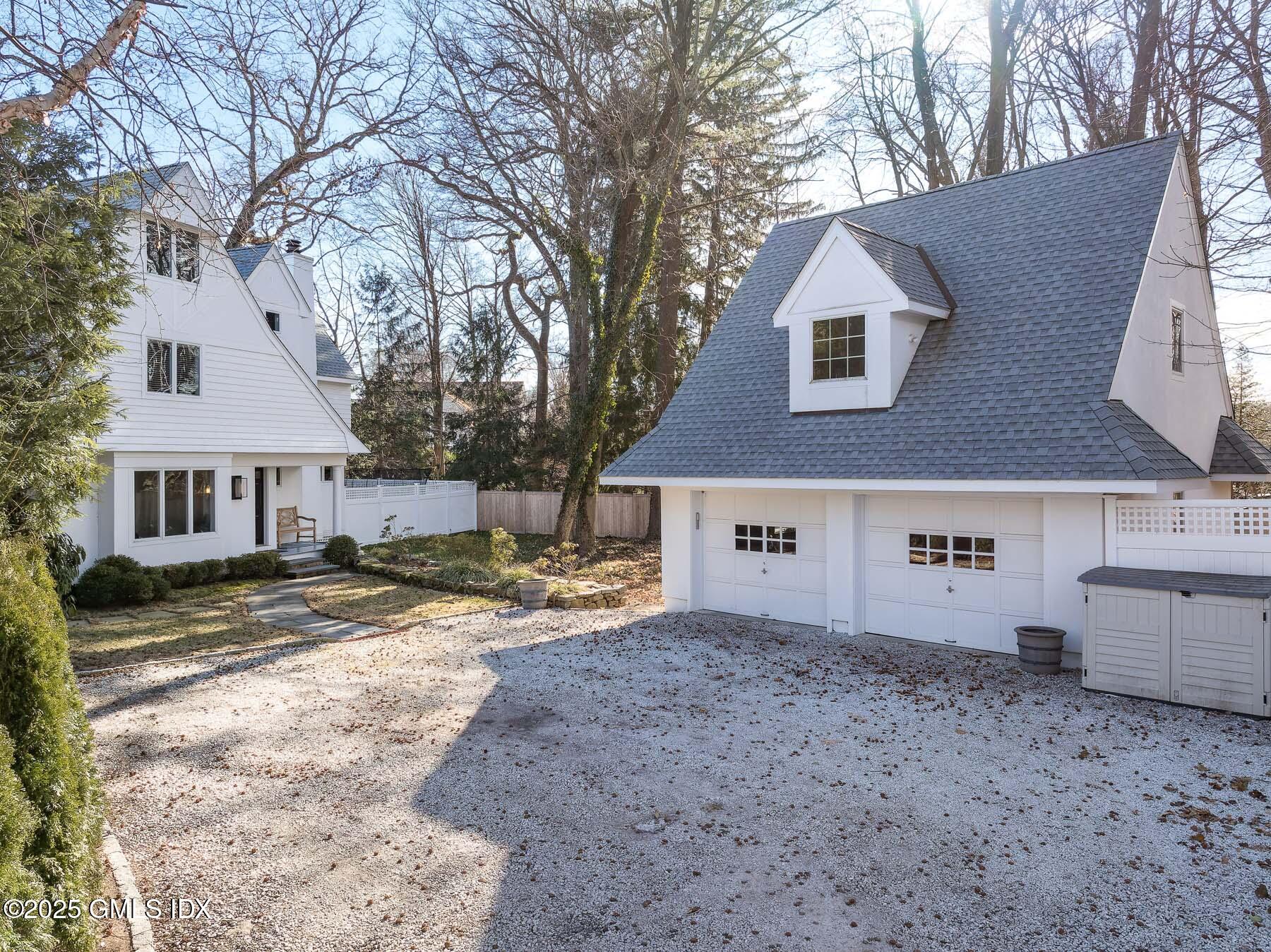 14 Tyler Lane Riverside, CT 06878 - Photo 1 of 1 a view of a house with a yard covered in snow