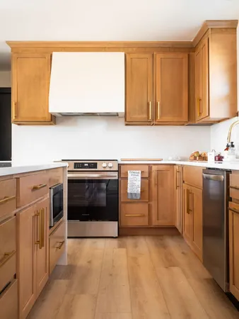 a kitchen with stainless steel appliances a stove top oven and a refrigerator