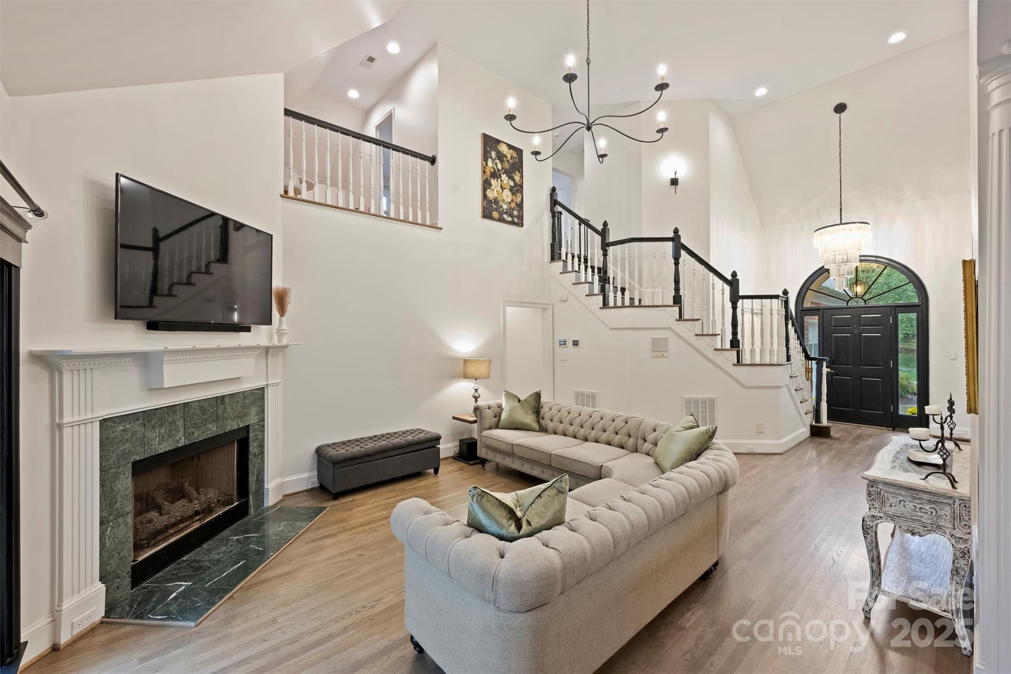 a living room with furniture fireplace and flat screen tv