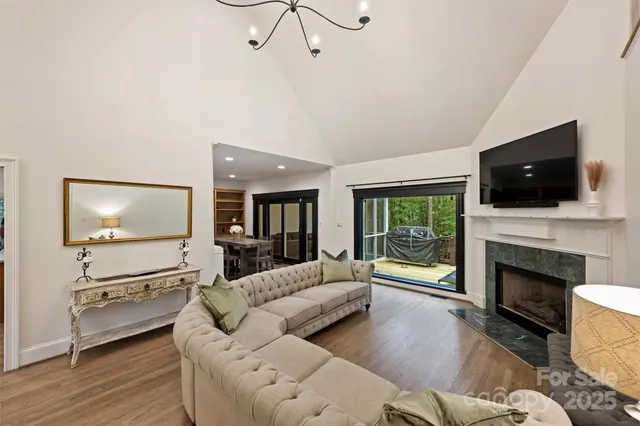 a living room with furniture fireplace and flat screen tv