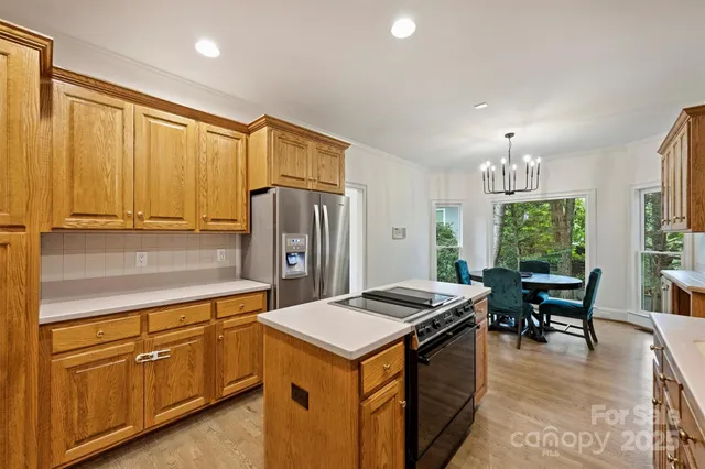 a kitchen that has a lot of cabinets in it and stainless steel appliances