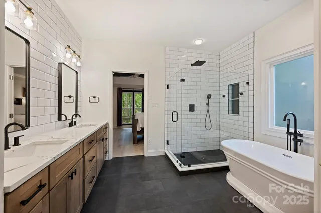 a bathroom with a double vanity sink double mirror and shower