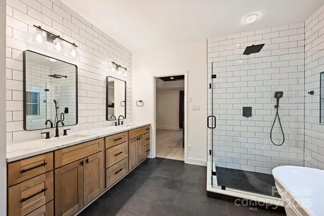 a bathroom with a double vanity sink toilet and shower