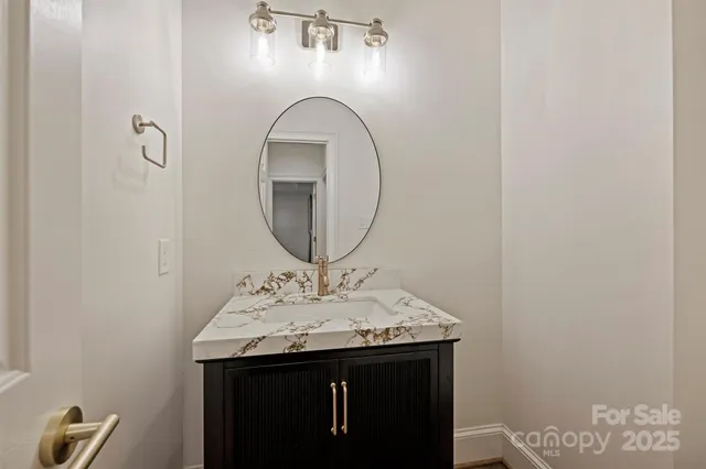 a bathroom with a sink a mirror and vanity