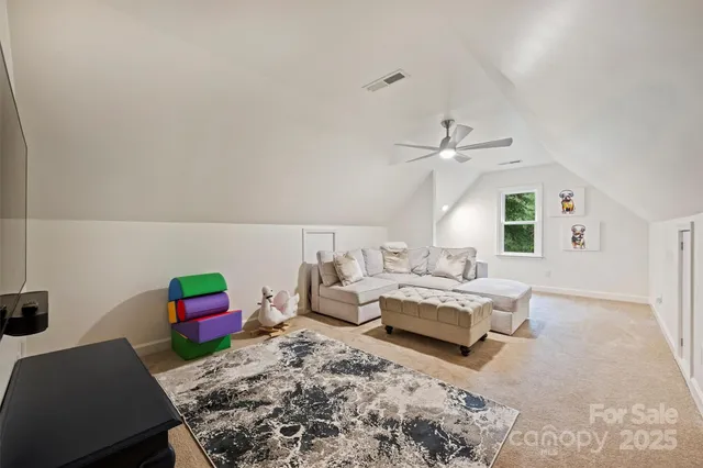 a living room with furniture a rug and a wall painting