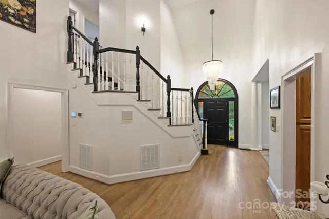 a view of entryway and hall with wooden floor