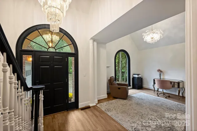 a view of a living room with furniture and a mirror
