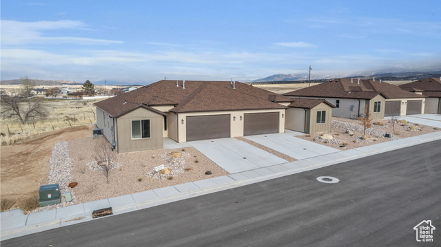 155 East 360th Street East, Unit 10B Fillmore, UT 84631 - Photo 35 of 43 Ranch-style house featuring a mountain view and a garage