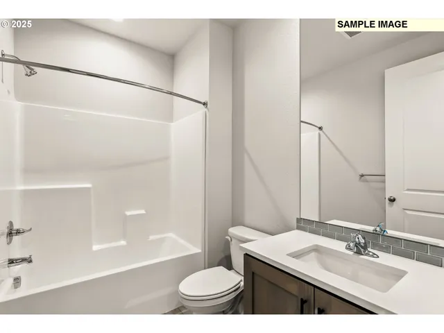 a bathroom with a sink a toilet a mirror and shower