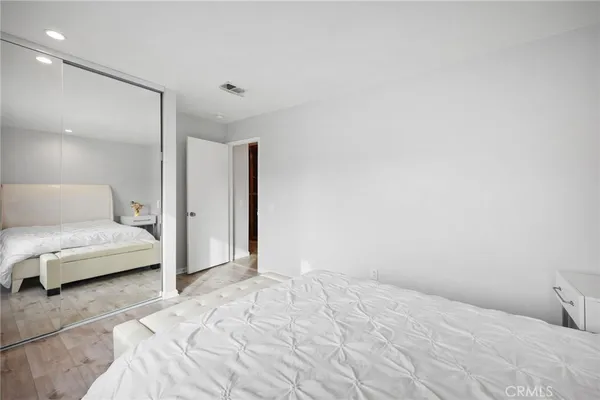 a bedroom with two beds and a night stand