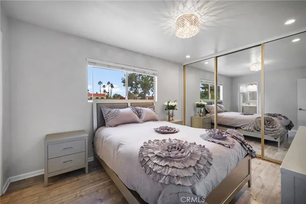 a bedroom with a bed and a chandelier