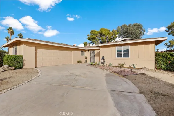 a view of a house with a backyard