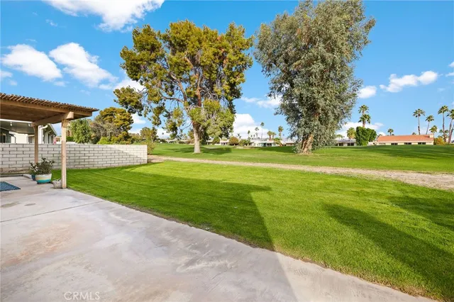 a front view of a house with a garden and yard