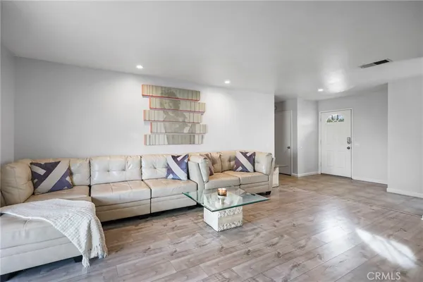a living room with furniture window and a wooden floor