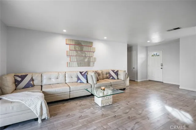 a living room with furniture window and a wooden floor