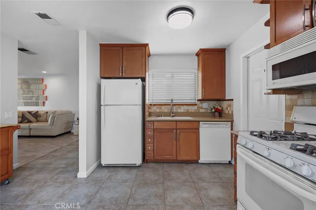 a kitchen with stainless steel appliances granite countertop a refrigerator and a stove