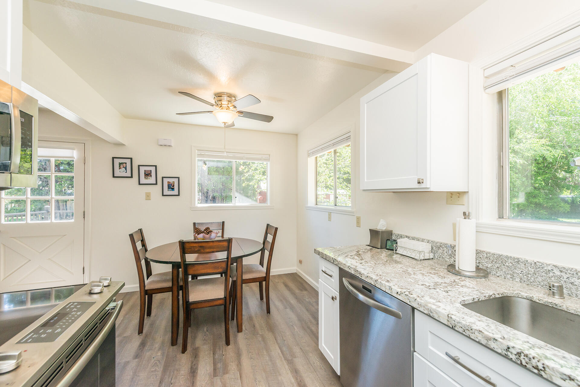 111 Scott Trinity Center Trinity Center, CA 96091 - Photo 13 of 46 a kitchen with a dining table chairs and white cabinets