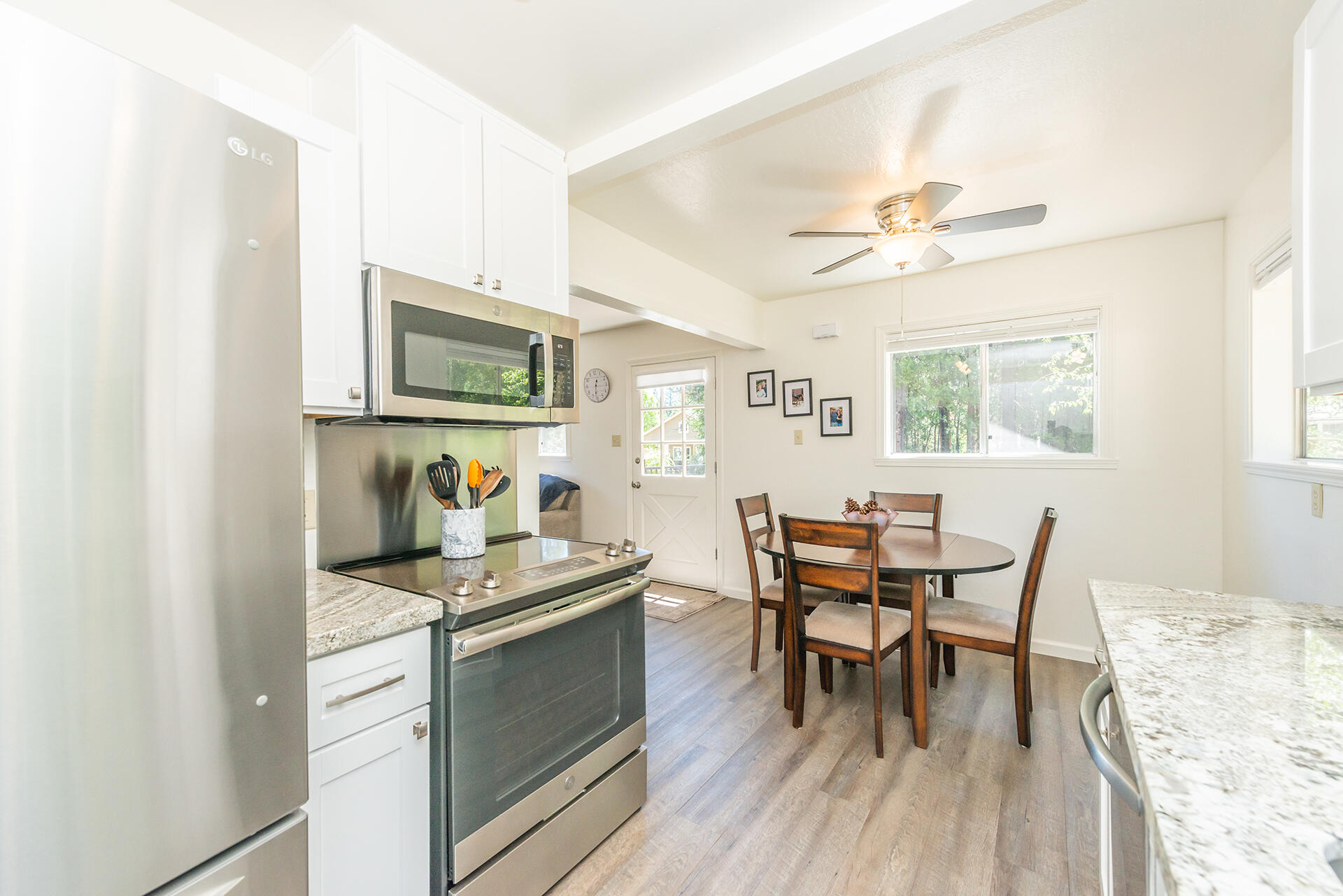111 Scott Trinity Center Trinity Center, CA 96091 - Photo 24 of 46 a kitchen with a table chairs and white cabinets