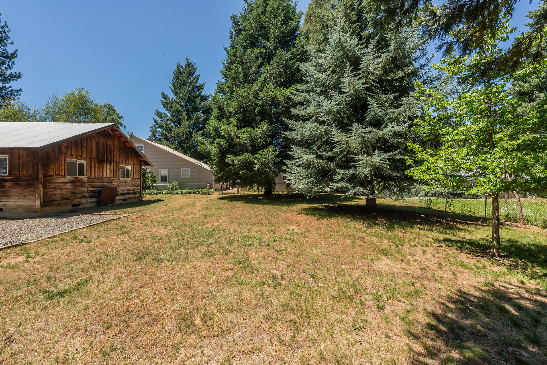 111 Scott Trinity Center Trinity Center, CA 96091 - Photo 35 of 46 a yellow house with trees in front of it