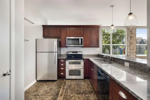 a kitchen with a refrigerator and a sink