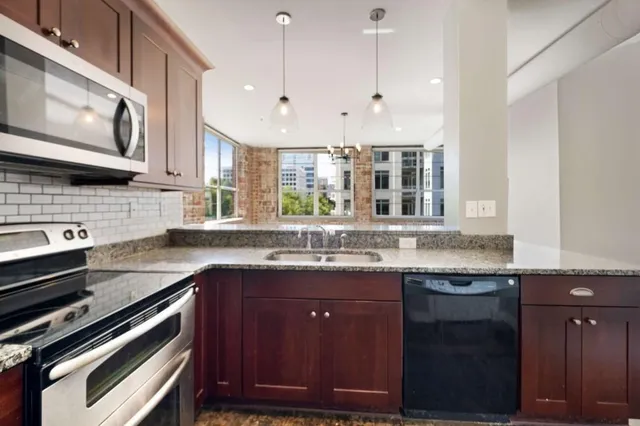 a kitchen with a sink stove and microwave