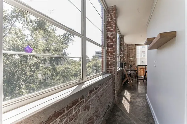 a bed sitting in a bedroom next to a window