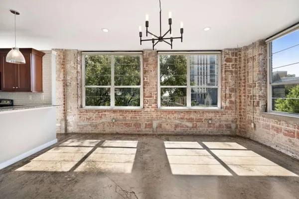 a view of empty room with windows and dual sinks