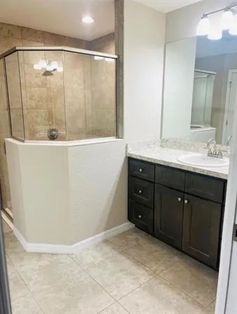 a bathroom with a double vanity sink a mirror and a bathtub