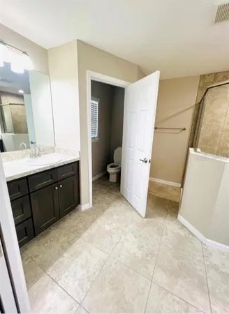 a bathroom with a double vanity sink and mirror