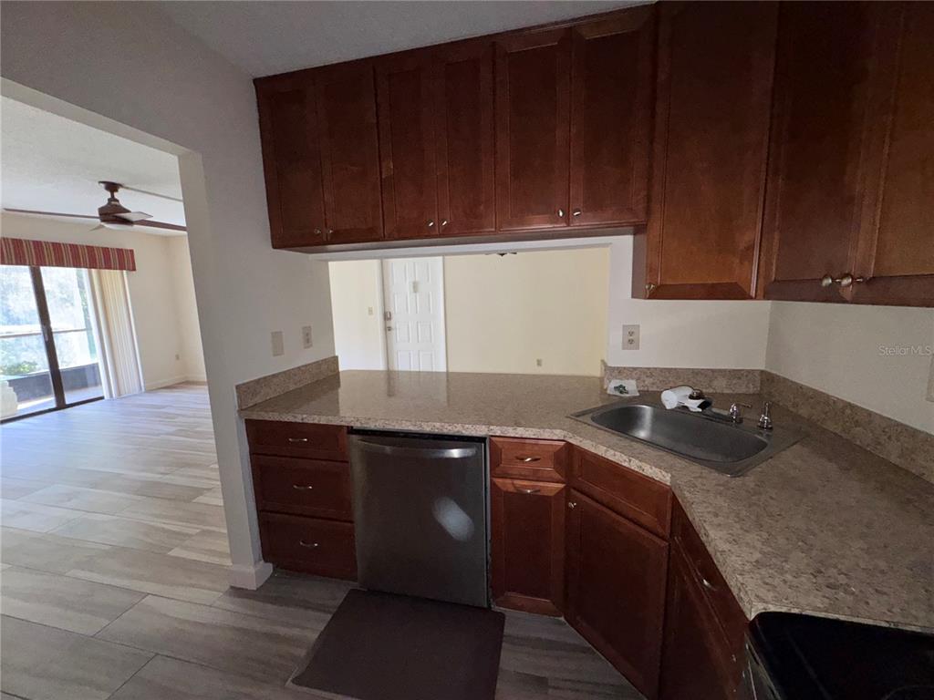 1372 Pine Ridge Circle East, Unit F1 Tarpon Springs, FL 34688 - Photo 16 of 21 a kitchen with a sink and cabinets