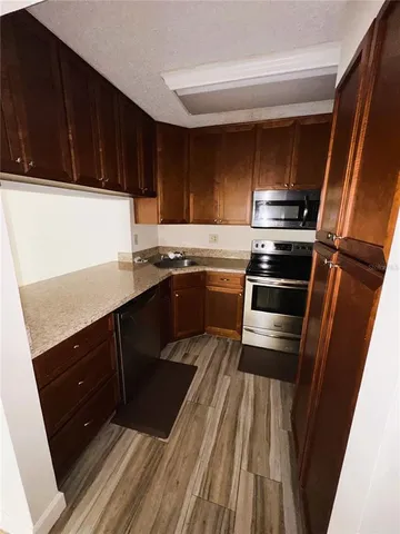 a kitchen with wooden cabinets and sink
