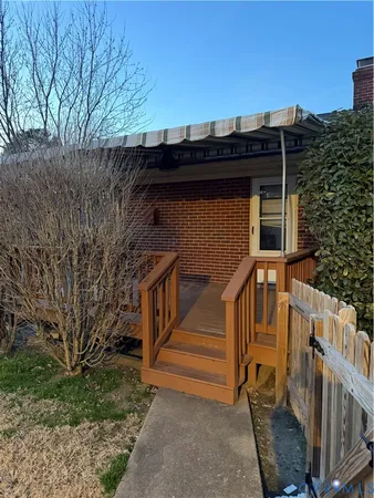 a view of a house with wooden fence